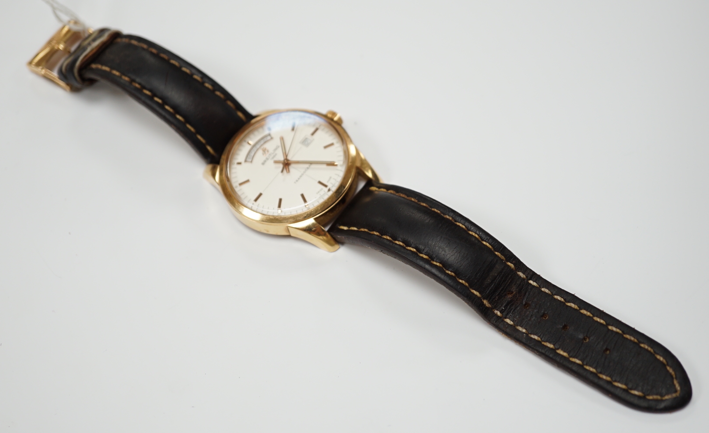 A gentleman's 2013 18ct gold Breitling Transocean automatic day/date wrist watch, with baton numerals, on a Breitling leather strap with 18ct gold Breitling buckle, the case back numbered R45310, No. 198, case diameter 4